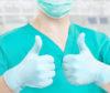 Successful dentist giving two thumbs up